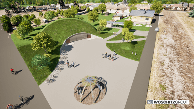 Luftaufnahme eines modernen Gebäudekomplexes mit begrüntem Dach in einer ländlichen Umgebung.