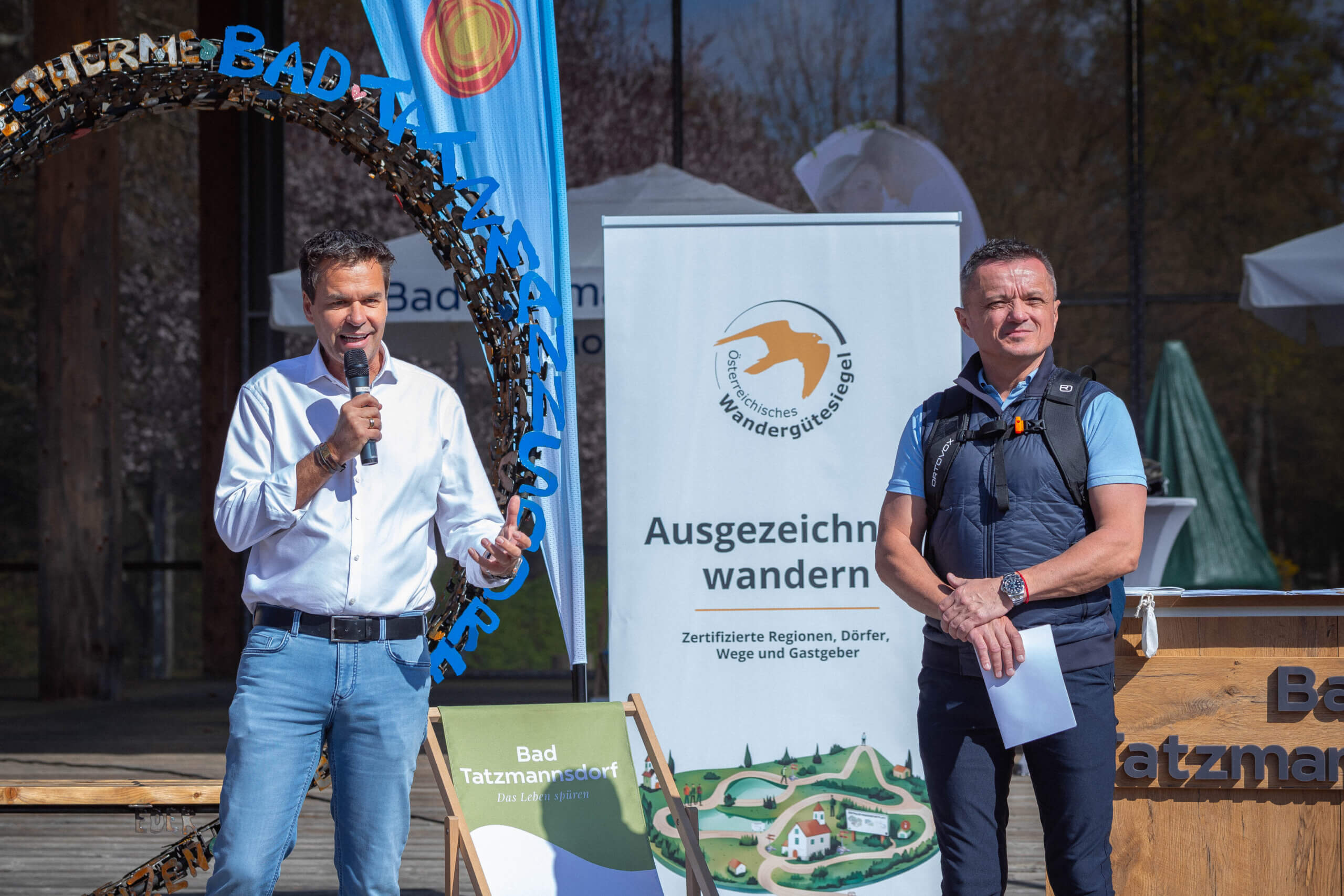 Zwei Männer präsentieren das Österreichische Wandergütesiegel in Bad Tatzmannsdorf.