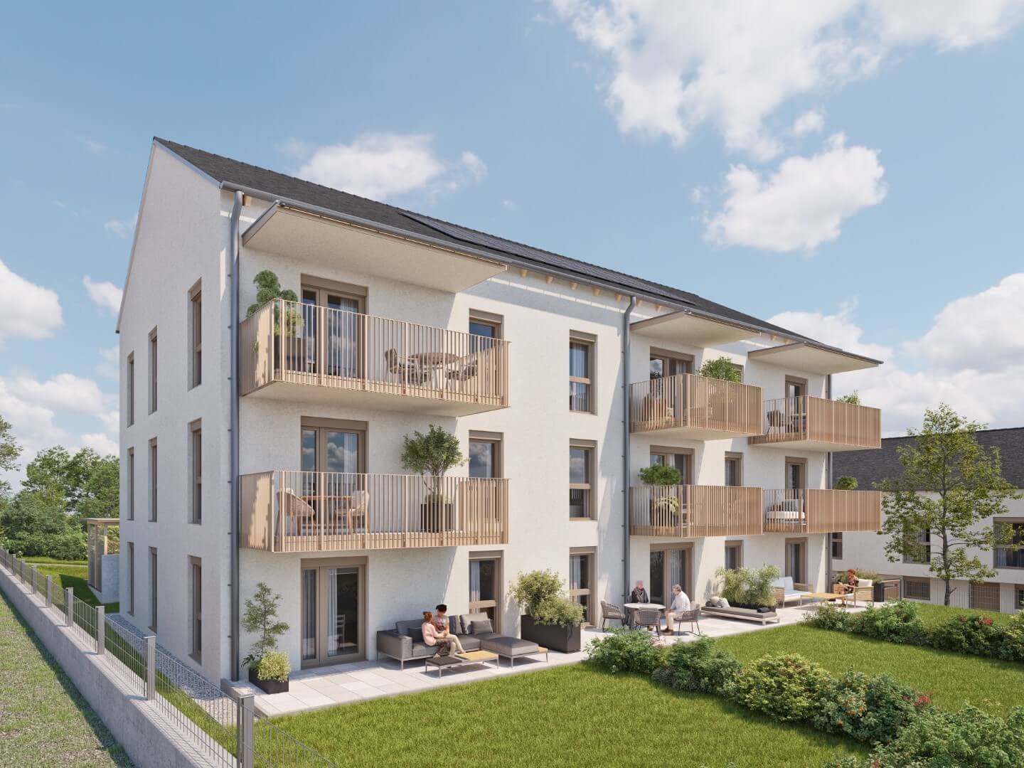 Mehrfamilienhaus mit Balkonen und Garten an einem sonnigen Tag, modernes Wohnen mit Naturblick.